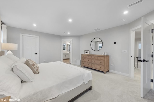 carpeted bedroom featuring ensuite bathroom