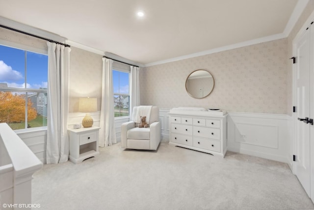 sitting room with ornamental molding, plenty of natural light, and light carpet