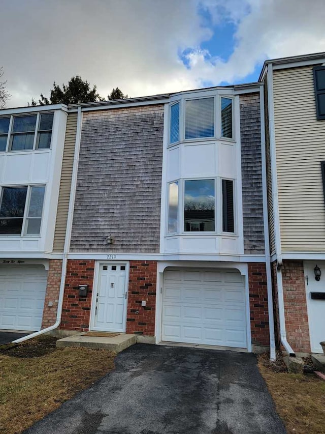 view of property with an attached garage and driveway