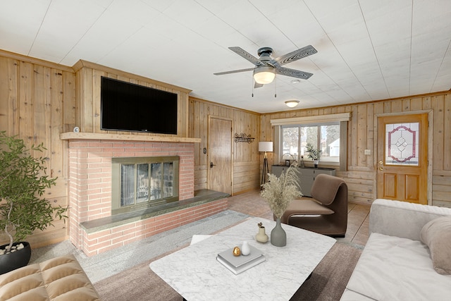 living room with ceiling fan and a fireplace