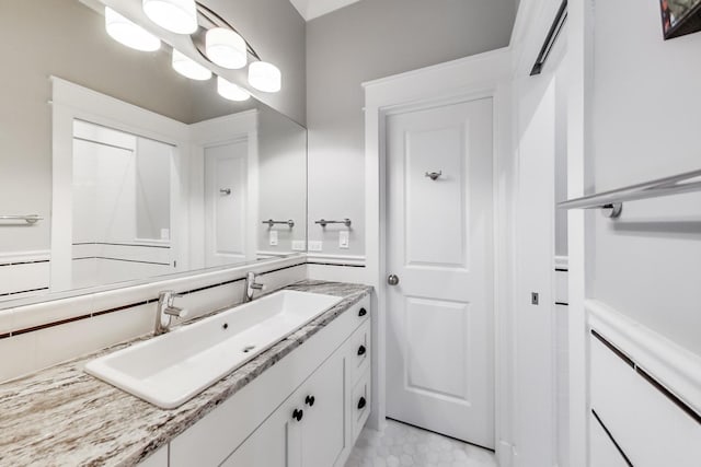 bathroom featuring tile patterned flooring and vanity