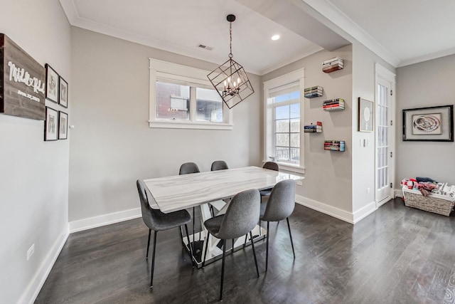 dining space with a notable chandelier, dark wood-type flooring, and ornamental molding