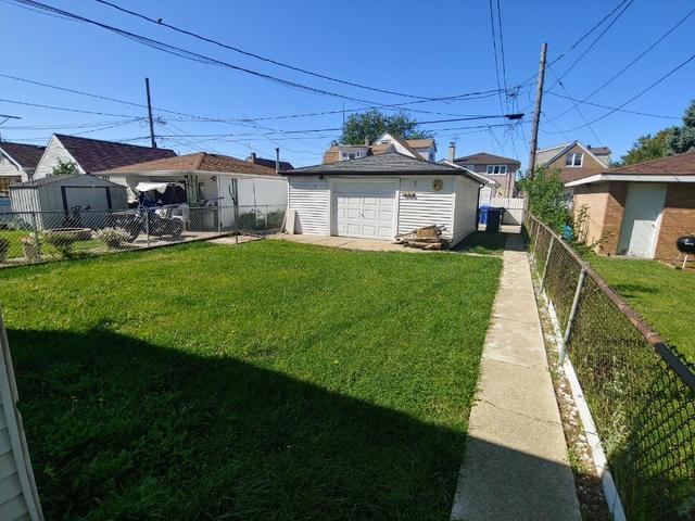 view of yard with a garage and an outdoor structure