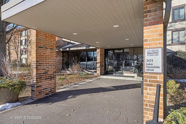 property entrance featuring a carport