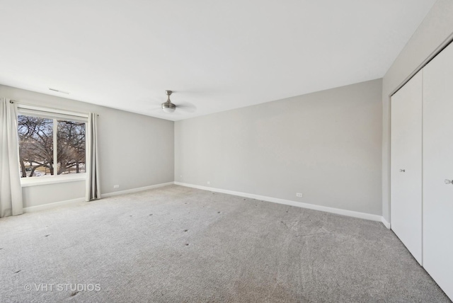 unfurnished bedroom with light colored carpet and a closet