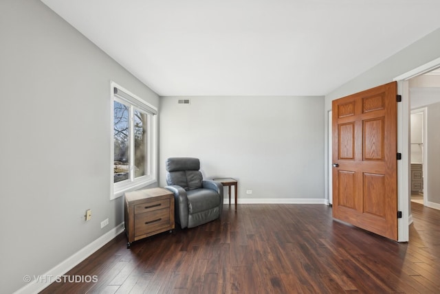 sitting room with dark wood-type flooring