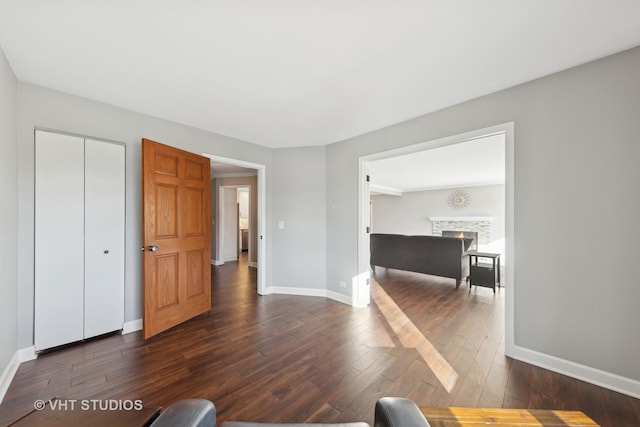 unfurnished living room featuring dark hardwood / wood-style floors and a fireplace