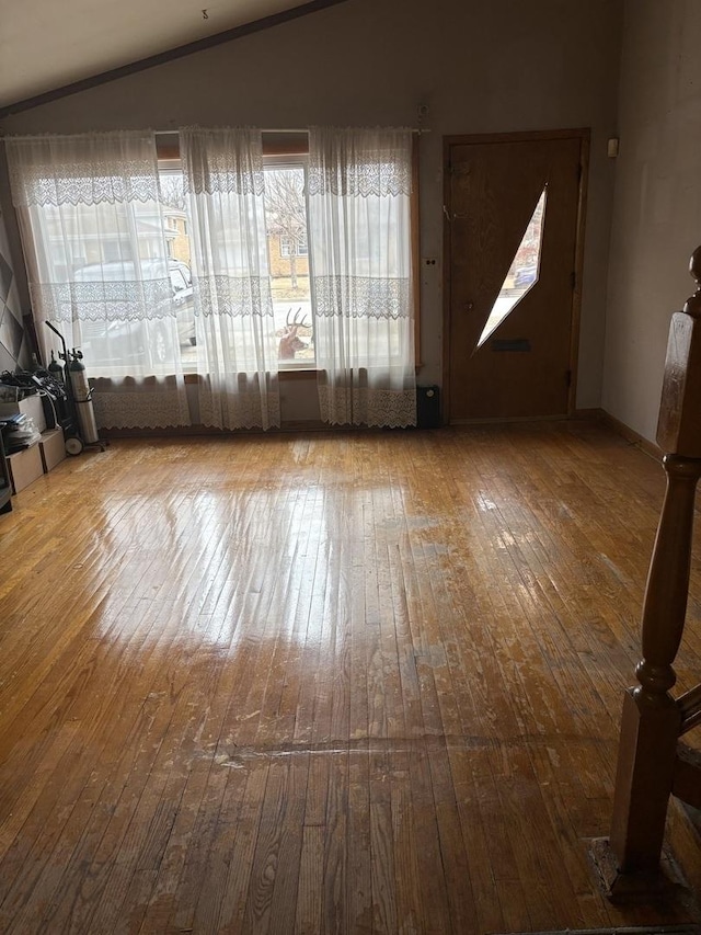 interior space with wood-type flooring and vaulted ceiling