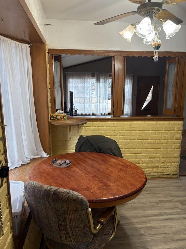 dining area with wood-type flooring and ceiling fan