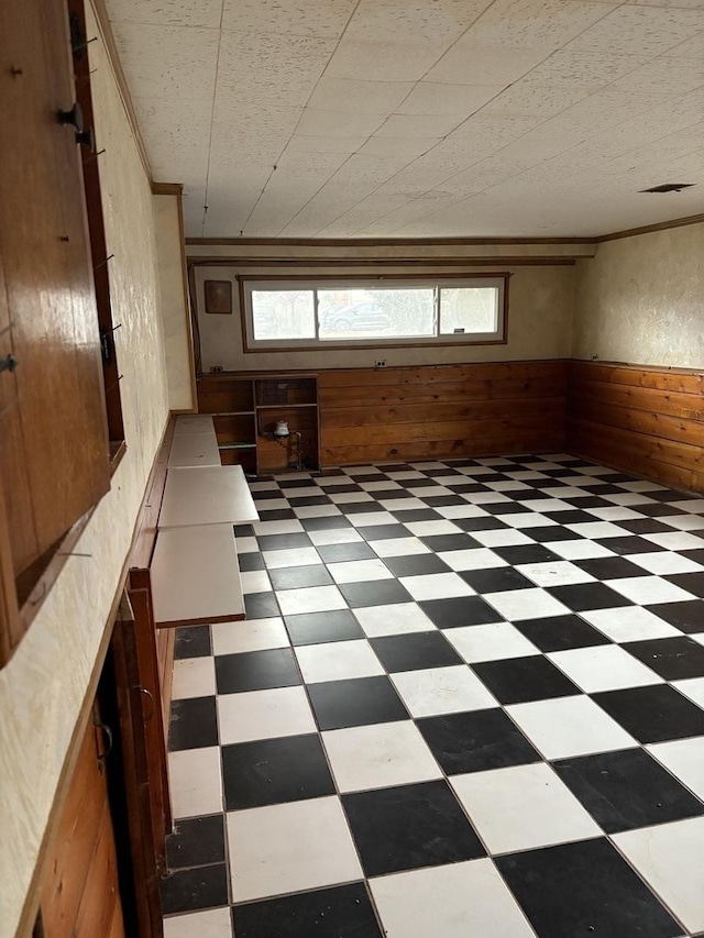 unfurnished room featuring wood walls