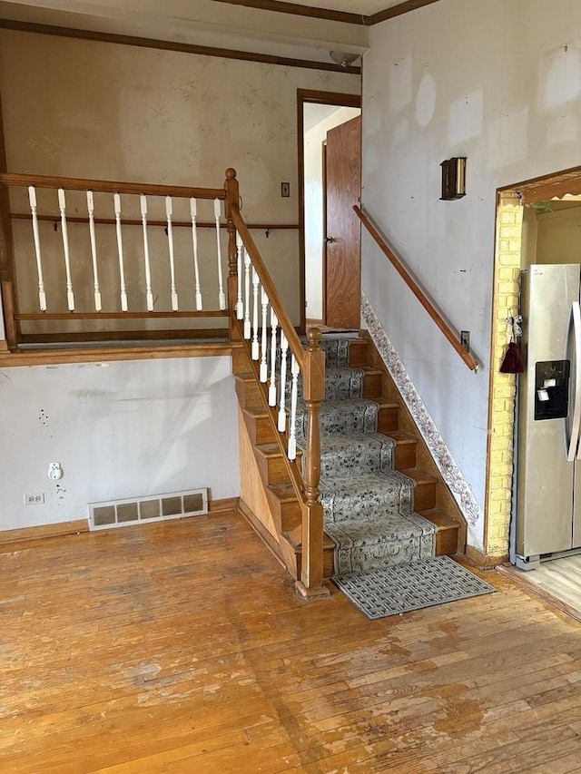 stairs with hardwood / wood-style flooring