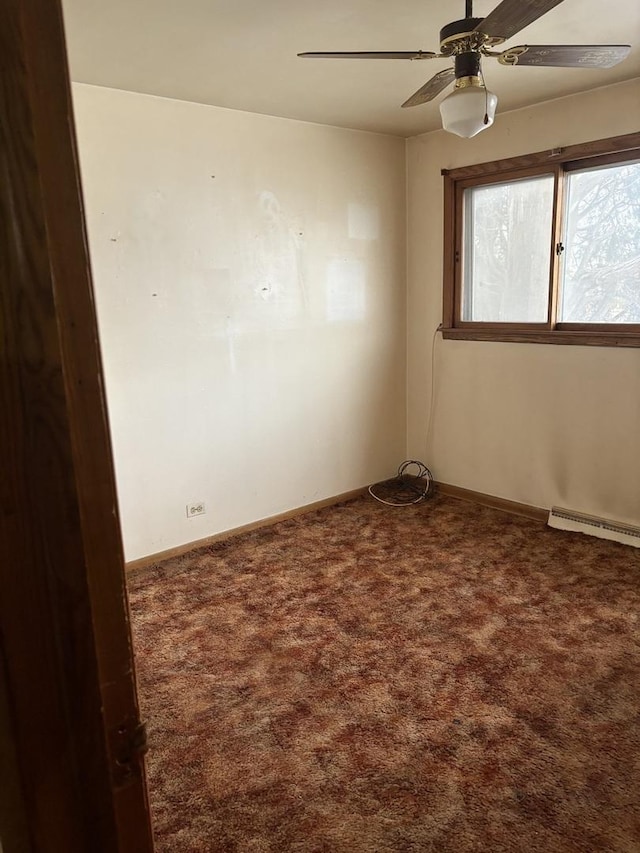 empty room with ceiling fan, dark carpet, and baseboard heating