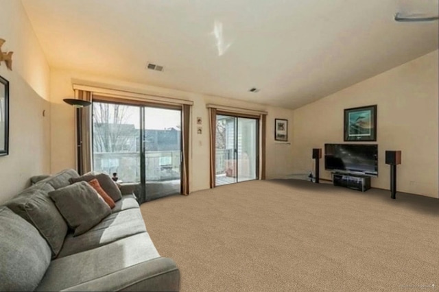 carpeted living room featuring lofted ceiling