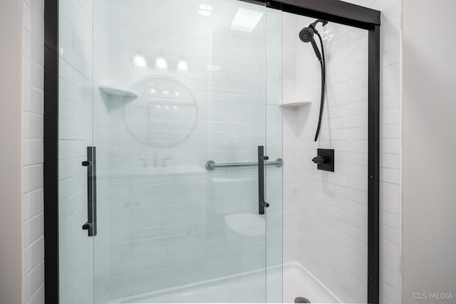 bathroom with a shower with shower door