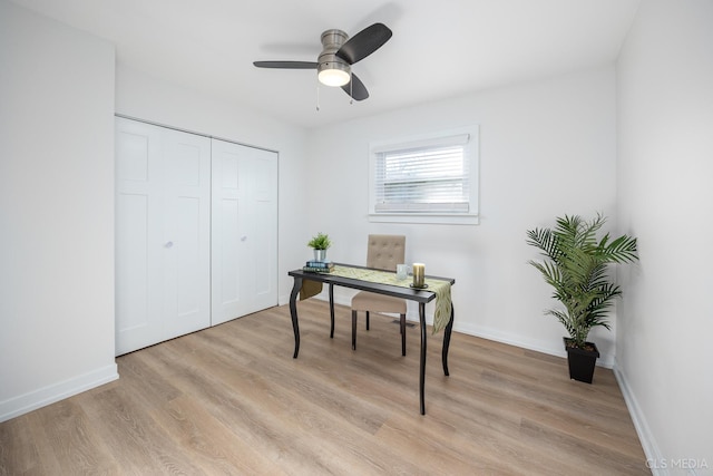 home office with ceiling fan and light wood-type flooring