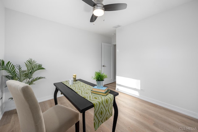 home office with ceiling fan and light hardwood / wood-style floors