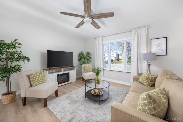 living room with light hardwood / wood-style floors and ceiling fan