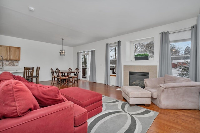 living room with light wood-type flooring and a fireplace