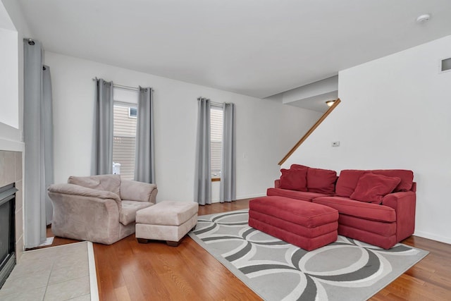 living room featuring a fireplace and light wood-type flooring