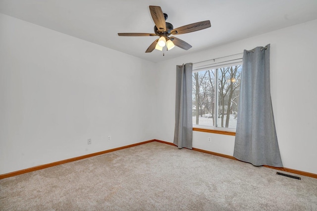 unfurnished room with ceiling fan and carpet floors