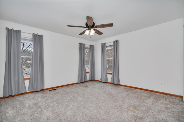 empty room featuring ceiling fan and carpet floors