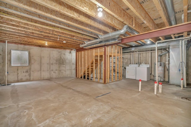 basement featuring washing machine and dryer and water heater