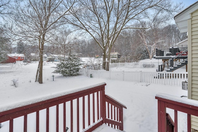 yard covered in snow featuring a wooden deck