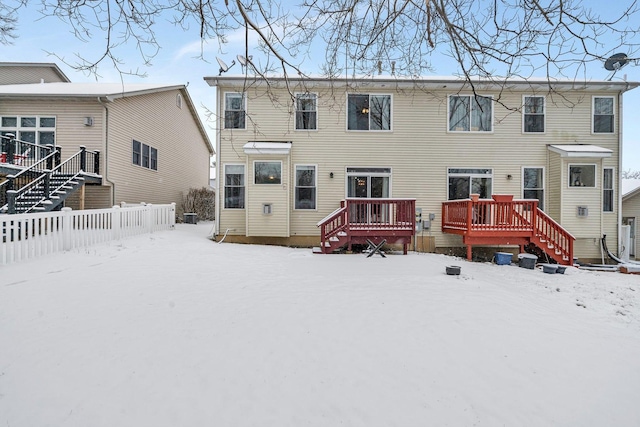 view of snow covered rear of property