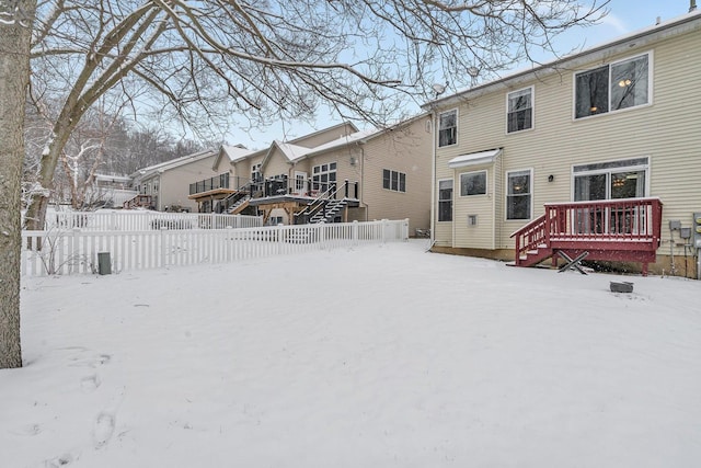 snow covered property with a wooden deck