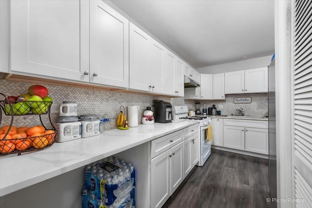 kitchen with white cabinetry, white range with gas cooktop, and tasteful backsplash