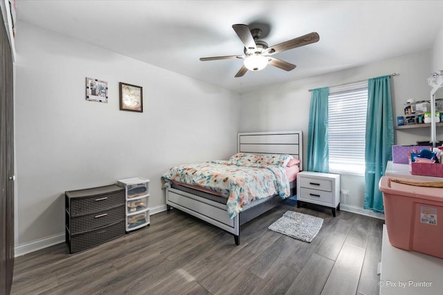 bedroom with dark hardwood / wood-style floors and ceiling fan