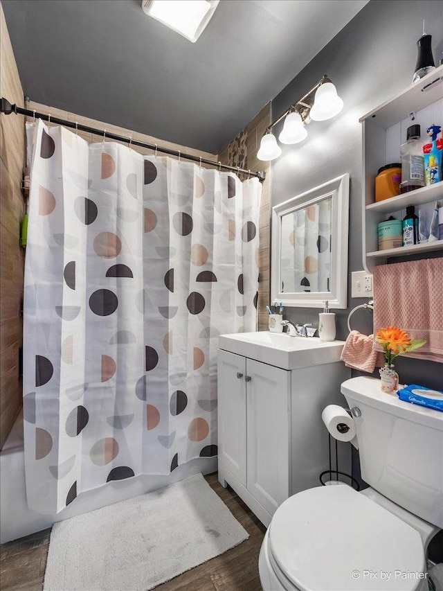 full bathroom with wood-type flooring, vanity, toilet, and shower / bath combination with curtain