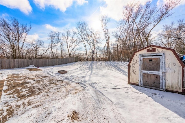 snowy yard with a shed