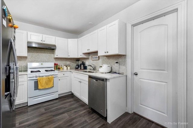 kitchen with decorative backsplash, stainless steel appliances, sink, dark hardwood / wood-style floors, and white cabinetry