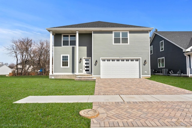 view of front property featuring central AC unit, a garage, and a front lawn