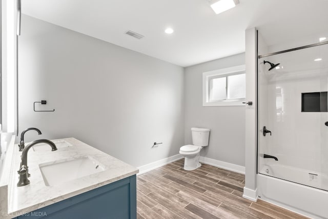 full bathroom with bathing tub / shower combination, hardwood / wood-style flooring, vanity, and toilet