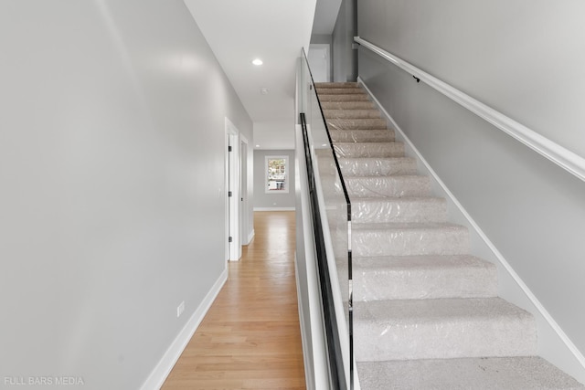 stairs featuring wood-type flooring