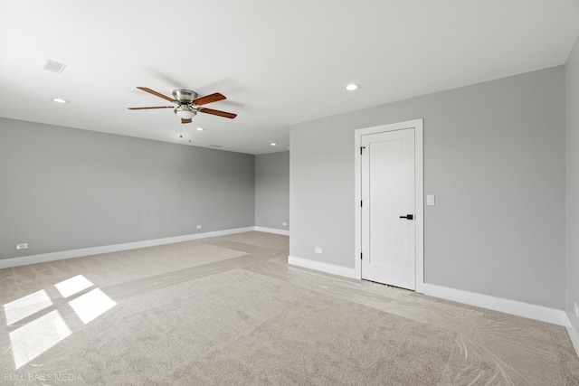 carpeted empty room featuring ceiling fan