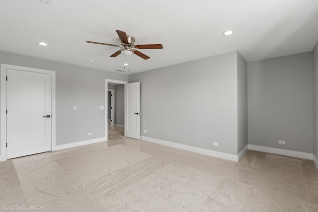 unfurnished room featuring ceiling fan and light carpet