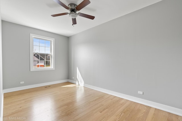 empty room with ceiling fan and light hardwood / wood-style floors