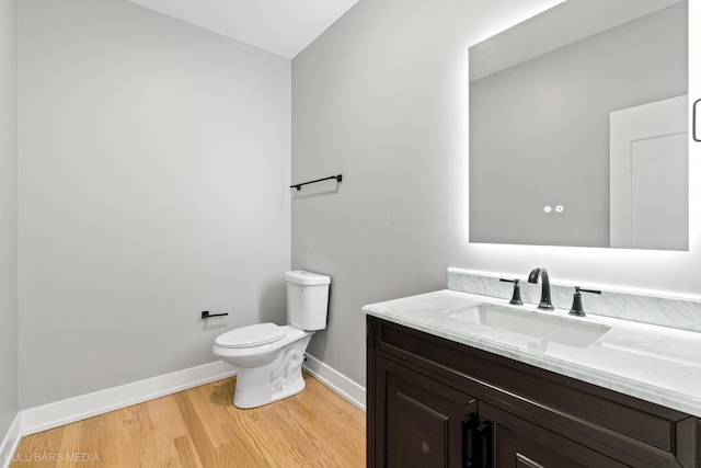 bathroom with vanity, wood-type flooring, and toilet