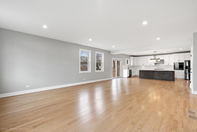 unfurnished living room featuring light wood-type flooring