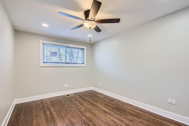 empty room with ceiling fan and dark wood-type flooring