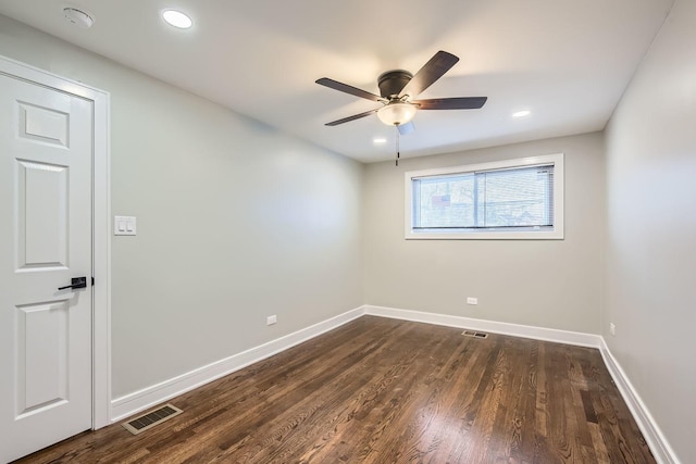 spare room featuring dark hardwood / wood-style floors and ceiling fan