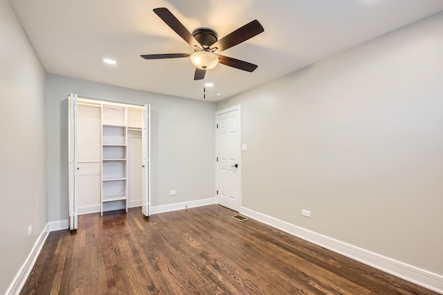 unfurnished bedroom with ceiling fan, a closet, and dark wood-type flooring