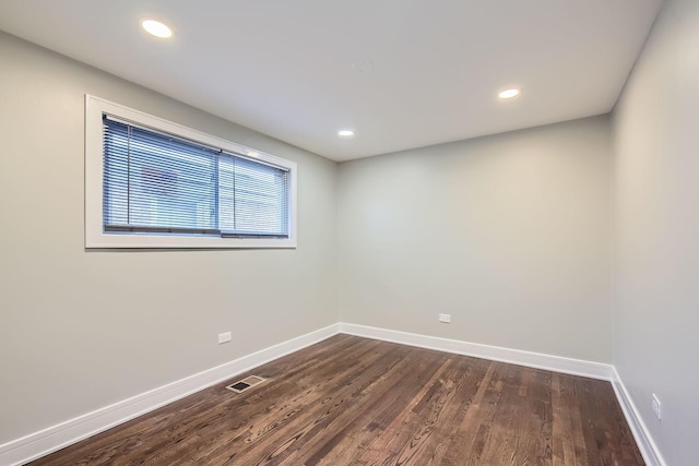 spare room with dark wood-type flooring