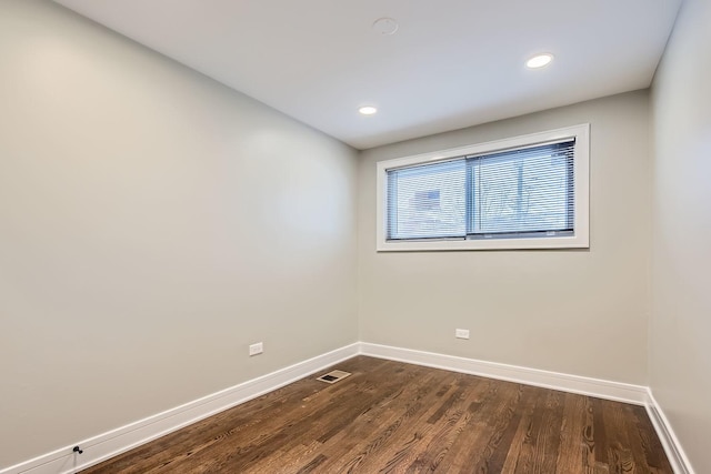 spare room featuring dark hardwood / wood-style flooring