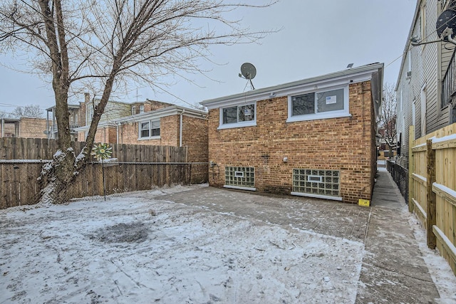 view of snow covered rear of property