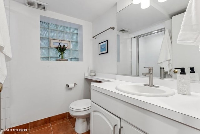 bathroom with tile patterned flooring, vanity, toilet, and an enclosed shower