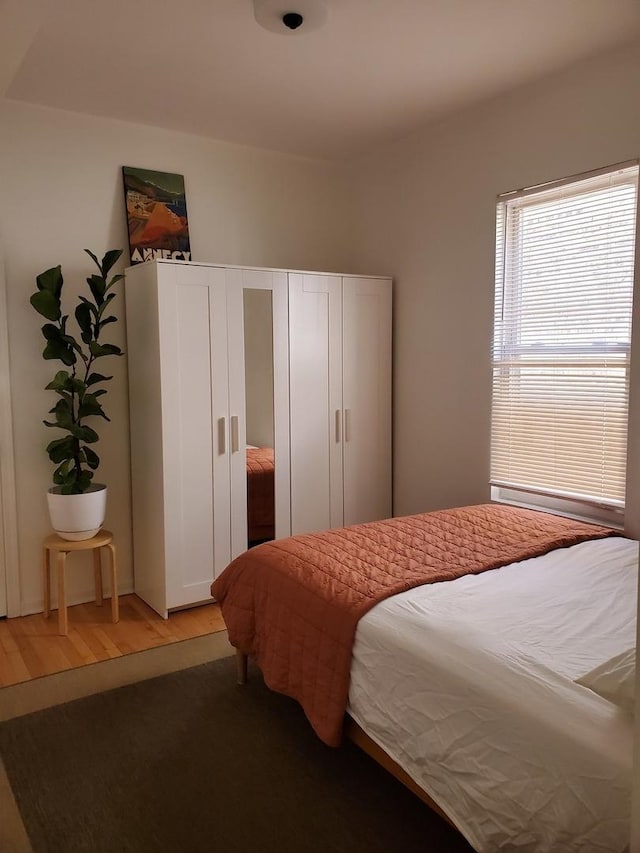 bedroom with wood-type flooring